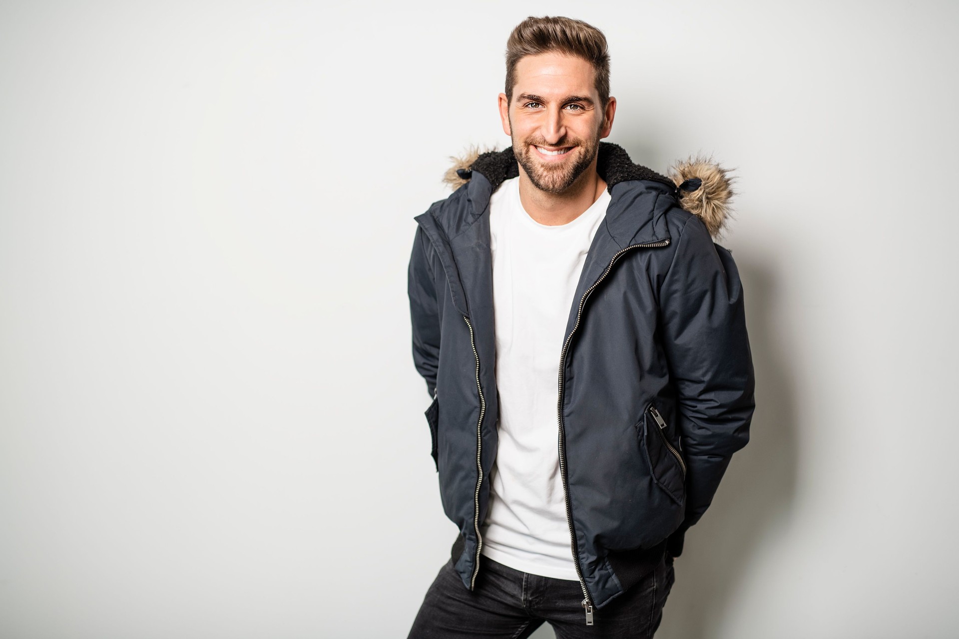 A Studio Portrait Of Young Man Wearing Winter Coat